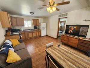 a woman in a living room with a couch and a kitchen at Whispering Pines #7 in Calumet