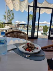 a plate of food sitting on top of a table at Vila Hyseni in Durrës