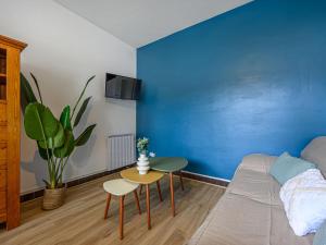 a blue room with a bed and a table at Holiday Home Arvor I-2 by Interhome in Carnac