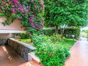 a garden with pink flowers on a building at Apartment Piccolo Leccio by Interhome in Cecina +37 photos