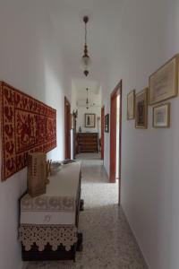 a room with a bed and a hallway at La Rotonda Fertilia apartment in Fertilia