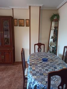 a dining room with a table with a quilt on it at Apartamento Casuca, terraza y jardín in Ajo