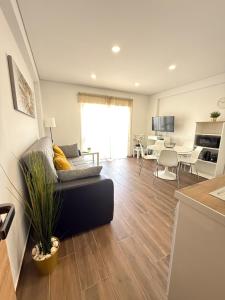 a living room with a couch and a table at Tomasoni summer house in Armação de Pêra