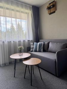 a living room with a couch and two tables at Villa Veranda in Smolyan