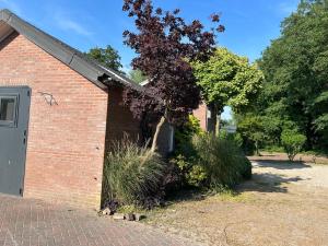 a brick building with a tree in front of it at Zonneoord in Ede