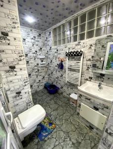 a bathroom with a toilet and a sink at Adem in Aïn El Turk +10 photos