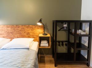 a bedroom with a bed with a wooden headboard at Adventure Hotel Hof in Hof