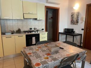 a kitchen with a table with a table cloth on it at Apartment Orio 1 e 2 in Orio al Serio