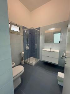 a bathroom with a shower and a toilet and a sink at Otranto - appartamento sul mare, parcheggio privato in Otranto
