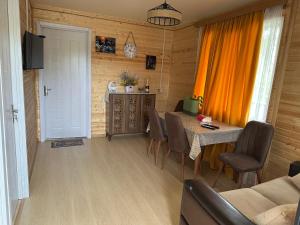 a living room with a table and chairs and a television at Villa T&O in Gonio