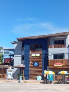 a building with umbrellas in front of it at Pousada Makai in Porto De Galinhas