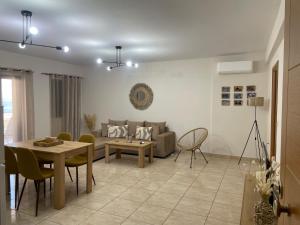 a living room with a couch and a table at Maria’s Apartment in Monemvasia
