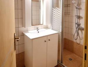 a bathroom with a white sink and a shower at Villa Nikolas by PosarelliVillas in Vamos +10 photos