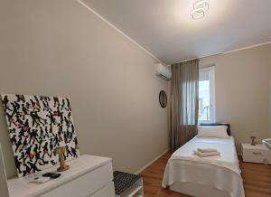 a white bedroom with a bed and a window at Alloggi Tosca Airport Lodges in Ronchi dei Legionari