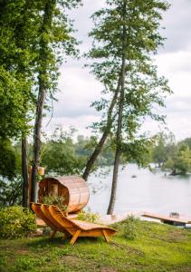 a wooden boat sitting on the grass near a lake at Le domaine de rountz in Rountzenheim