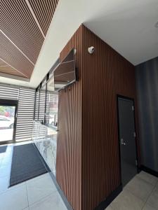 a room with a wooden wall and a door at Capital Hotel Long Island City in Queens