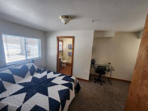 a bedroom with a bed and a desk and a window at Whispering Pines #4 in Calumet