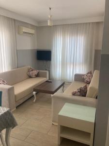 a living room with two couches and a table at Mavi Çatı C Blok in Merdivenlikuyu