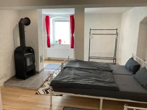 a bedroom with a bed and a stove at Ferienwohnung bei Aschersleben mit Wlan in Aschersleben