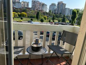 a balcony with a table and chairs and a view of a city at Loft NUOVO vicino al centro - OASI Relax in Turin