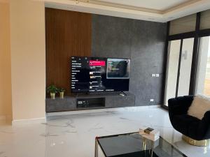 a living room with a flat screen tv on a wall at ازهى السخنه Azha in Ain Sokhna