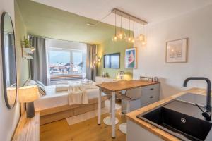 a bathroom with a sink and a desk in a room at Boutique-Apartment Rubiblick in Oberstdorf