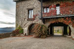 a stone building with a balcony and a door at Santuari de Santa Maria de Montgrony in Gombreny