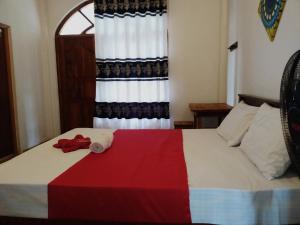 a hotel room with a bed with a towel on it at Villa Suriya in Tennekumbura
