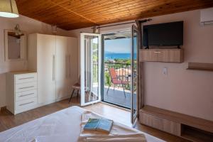 a bedroom with a bed and a view of the ocean at Meltemi in Parga