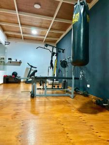 a gym with a punching bag hanging from the wall at Complejo Turístico Mendoza in Godoy Cruz +43 photos