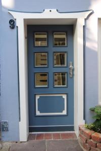 a blue door with a window on a house at Schmuckstück in Bremen