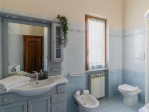 a bathroom with a sink and a toilet and a mirror at Apartment Roseto Down Town by Interhome in Roseto degli Abruzzi