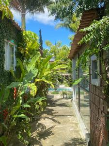 a path between two houses with trees and plants at Studio Chica Fulô - Village Capixaba in Gravatá