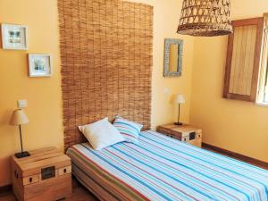 a bedroom with a bed with two night stands and two lamps at Holiday Home Villa Alecrim by Interhome in Comporta