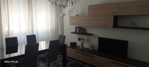 a living room with a dining table and a television at Casa delle fiabe in Sestri Levante