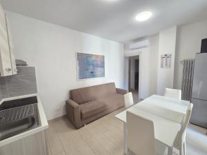 a living room with a couch and a table at Appartamento Morelli Beach - Via Fratti 2 in Follonica