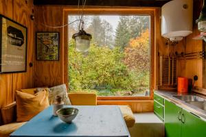 a kitchen with a table in front of a window at Swedish Quarry Guesthouse in Lönsboda +14 photos