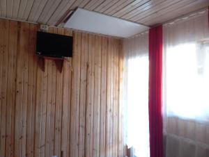 a room with wood paneled walls and a television on the wall at Casa Tudor Turda in Turda
