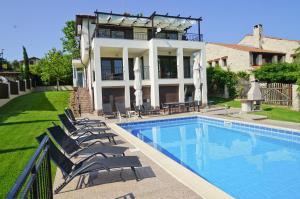a house with a swimming pool in front of a house at Six bedroom luxury villa with private pool in quiet residential area near beaches in Sozopol