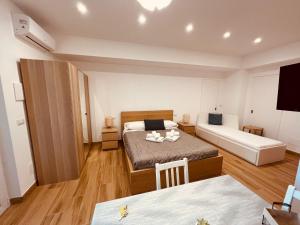 a small room with a bed and a couch at Trinacria apartments Falcone in Falcone