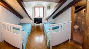 a bedroom with two beds in a attic at Villa Franovic in Dubrovnik