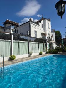 a large swimming pool in front of a house at Devedzic in Vrnjačka Banja