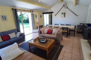 a living room with two couches and a table at Domaine Guiton Le Colombier in Chamaret