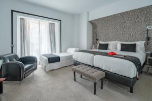 Postel nebo postele na pokoji v ubytování Mariposa Hotel Malaga