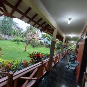 a balcony with chairs and a view of a park at Villa Kusuma 14, Large Garden & Karaoke in Batu City in Batu +10 photos