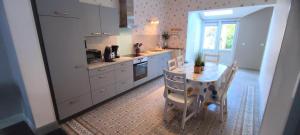 a kitchen with a table and a table and chairs at L'espÉrance 2 in Haybes