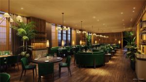 a restaurant with green tables and chairs and plants at Condo Downtown in Miami