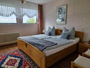 a bedroom with a large bed with blue pillows at Eifel-FeWo by Eva Kröll in Manderscheid