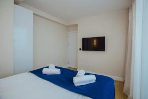 A bed or beds in a room at DOWNTOWN Centre in Batumi Aparthotel Orbi City N1