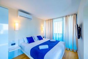 A bed or beds in a room at DOWNTOWN Centre in Batumi Aparthotel Orbi City N1